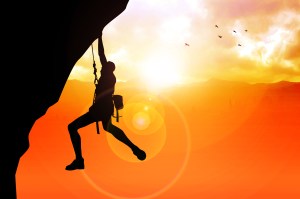 Silhouette illustration of a man figure hanging on the cliff